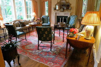 Living room - mid-sized traditional formal and enclosed medium tone wood floor living room idea in Atlanta with beige walls, a standard fireplace, a plaster fireplace and no tv