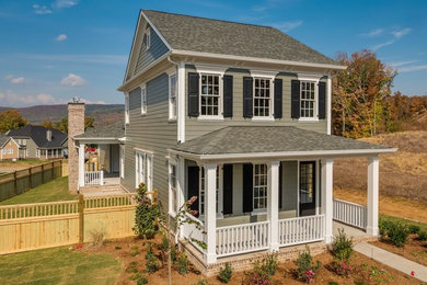 Example of a mid-sized classic gray two-story concrete fiberboard gable roof design in Other