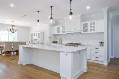 Design ideas for a large traditional open plan kitchen in Sunshine Coast with an undermount sink, shaker cabinets, white cabinets, quartzite benchtops, mosaic tile splashback, stainless steel appliances and with island.