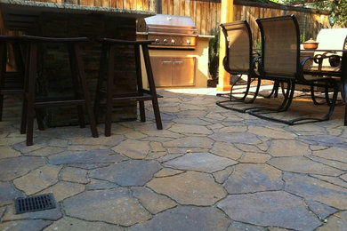 This is an example of a mid-sized traditional backyard patio in Boise with an outdoor kitchen, brick pavers and a pergola.