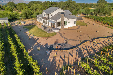 Inspiration for a country white two-story concrete fiberboard house exterior remodel in Denver with a metal roof