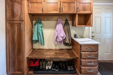 Inspiration for a mid-sized transitional vinyl floor and brown floor mudroom remodel in Cleveland with beige walls