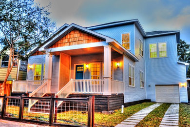 Example of a mid-sized arts and crafts blue two-story vinyl house exterior design in Houston with a hip roof and a shingle roof