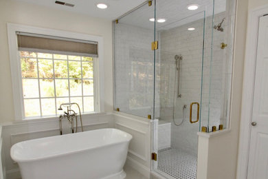 Bathroom - large transitional white tile and ceramic tile ceramic tile, gray floor, single-sink and wainscoting bathroom idea in Baltimore with shaker cabinets, dark wood cabinets, a two-piece toilet, beige walls, a drop-in sink, quartz countertops, a hinged shower door, white countertops and a freestanding vanity