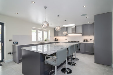 This is an example of a large traditional u-shaped kitchen in Hertfordshire with an island.