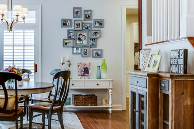Inspiration for a mid-sized transitional dining room in DC Metro with white walls, plywood floors and brown floor.