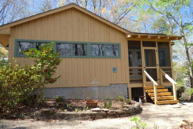 Example of a mid-sized yellow one-story exterior home design in Charlotte