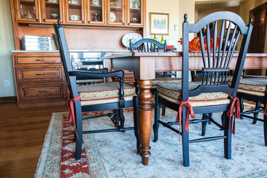 Mid-sized elegant u-shaped medium tone wood floor and brown floor eat-in kitchen photo in Omaha with an undermount sink, raised-panel cabinets, medium tone wood cabinets, granite countertops, beige backsplash, travertine backsplash, stainless steel appliances, two islands and beige countertops