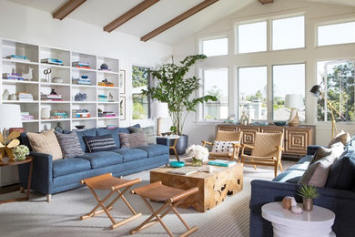 Beach style family room in Los Angeles with a library, white walls and dark hardwood floors.