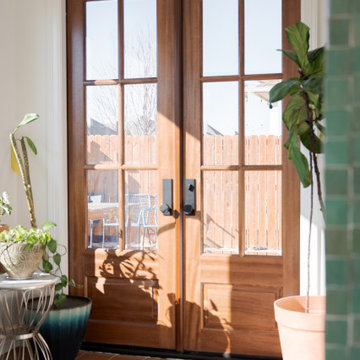 Arched Built-Ins Meet Terracotta Tile in a Light-Filled Sunroom Addition