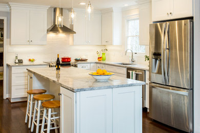 Large transitional l-shaped dark wood floor eat-in kitchen photo in DC Metro with an undermount sink, shaker cabinets, white cabinets, granite countertops, white backsplash, porcelain backsplash, stainless steel appliances and an island