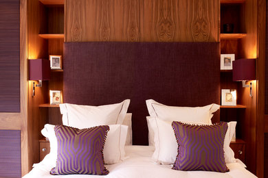 Inspiration for a mid-sized contemporary master bedroom in London with purple walls, carpet and no fireplace.