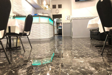 Mid-sized minimalist galley porcelain tile and black floor eat-in kitchen photo in Montreal with beaded inset cabinets, gray cabinets and an island