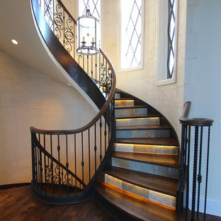 Photo of an expansive classic wood curved wood railing staircase in Nashville with slate risers.