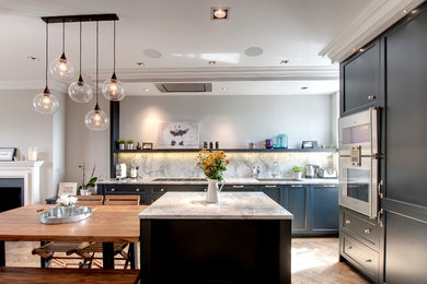 Medium sized contemporary open plan kitchen in London with shaker cabinets, blue cabinets, an island, a submerged sink, granite worktops, medium hardwood flooring, stone slab splashback and integrated appliances.