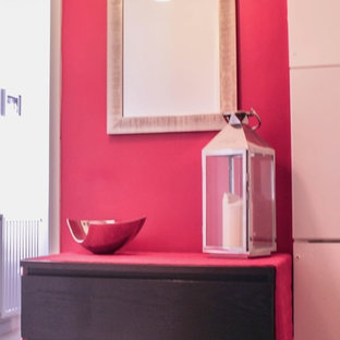 Inredning av en eklektisk liten farstu, med rosa väggar och målat trägolv