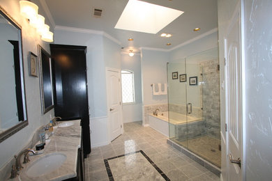 Elegant ceramic tile and gray floor alcove bathtub photo in Dallas with black cabinets, blue walls, a vessel sink, marble countertops, a hinged shower door and white countertops