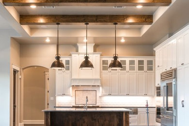 Example of a large farmhouse l-shaped dark wood floor and brown floor open concept kitchen design in Austin with an undermount sink, shaker cabinets, white cabinets, granite countertops, subway tile backsplash, stainless steel appliances, an island and white backsplash