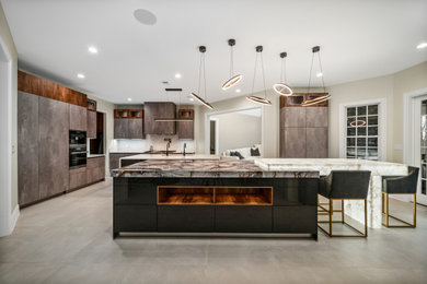 Huge trendy l-shaped porcelain tile and gray floor open concept kitchen photo in DC Metro with an undermount sink, flat-panel cabinets, gray cabinets, onyx countertops, white backsplash, stone slab backsplash, paneled appliances, two islands and white countertops