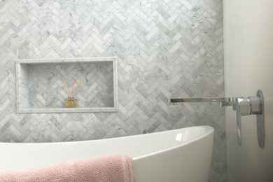 Photo of a bathroom in Sydney with medium wood cabinets, a freestanding tub and marble.