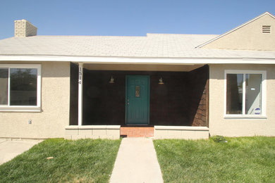 Inspiration for a small mid-century modern gray one-story stucco house exterior remodel in Las Vegas with a shingle roof