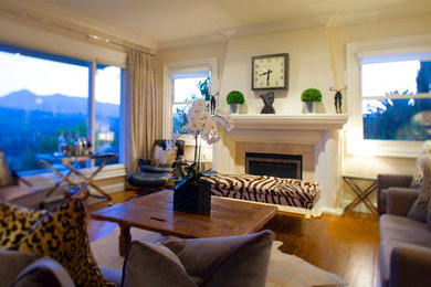 Inspiration for a large contemporary formal and open concept medium tone wood floor living room remodel in San Francisco with beige walls, a standard fireplace, a stone fireplace and no tv