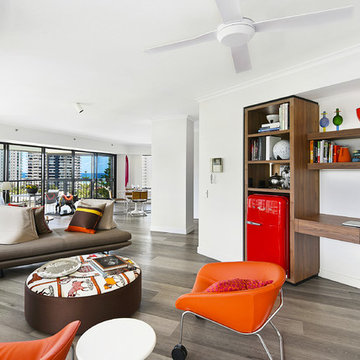 Custom built-ins with illuminated open cabinets complete the media room
