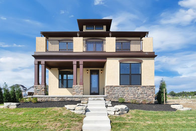 Tuscan two-story stucco house exterior photo in Columbus with a shingle roof