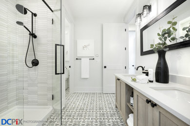 Alcove shower - 3/4 white tile gray floor alcove shower idea in Calgary with beige cabinets, white walls, a hinged shower door and white countertops
