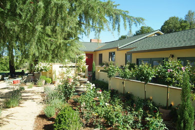 Inspiration for a mid-sized timeless yellow one-story stucco exterior home remodel in San Francisco with a shingle roof