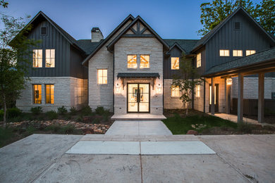 Large eclectic gray two-story gable roof idea in Dallas