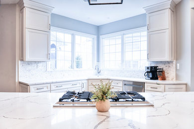 Design ideas for an expansive transitional galley eat-in kitchen in DC Metro with an undermount sink, beaded inset cabinets, white cabinets, quartzite benchtops, white splashback, marble splashback, stainless steel appliances, with island, brown floor, white benchtop and light hardwood floors.