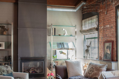 Inspiration for a mid-sized eclectic formal loft-style living room in Boston with grey walls, carpet, a standard fireplace, a concrete fireplace surround, grey floor, exposed beam and brick walls.
