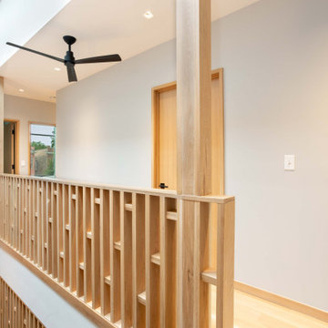 Second Floor Landing with Custom Oak Railing and Vaulted Ceiling | Chicago Moder