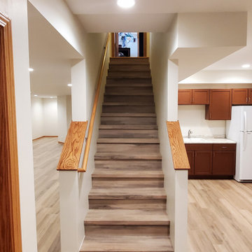 Finished basement vinyl plank floor with matching stairs
