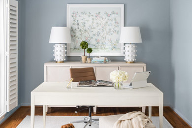 Home office - small traditional freestanding desk medium tone wood floor and brown floor home office idea in DC Metro with blue walls