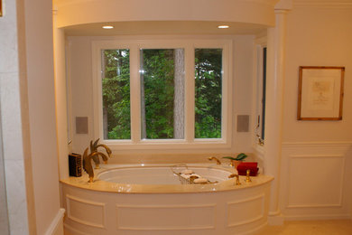 Example of a large classic master beige tile and porcelain tile ceramic tile bathroom design in Seattle with an undermount sink, raised-panel cabinets, white cabinets, granite countertops, a two-piece toilet and beige walls