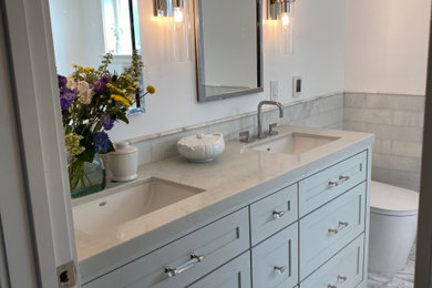 Mid-sized transitional master bathroom in San Francisco with shaker cabinets, grey cabinets, a freestanding tub, a corner shower, a one-piece toilet, gray tile, marble, white walls, marble floors, engineered quartz benchtops, grey floor, grey benchtops, a shower seat, a double vanity, a built-in vanity and decorative wall panelling.