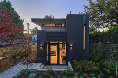 Design ideas for a modern two-storey grey exterior in Vancouver with mixed siding and a flat roof.