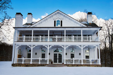 Large traditional white two-story wood and clapboard exterior home idea in New York