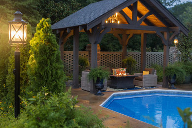 This is an example of a mid-sized traditional backyard patio in Other with a gazebo/cabana.