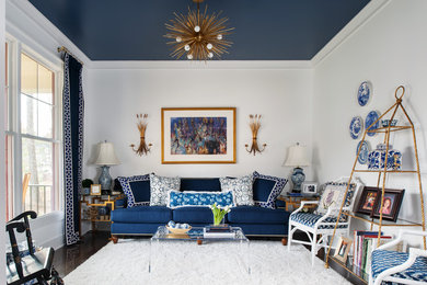 Example of a mid-sized trendy enclosed medium tone wood floor living room design in Richmond with white walls