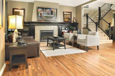 Inspiration for a large timeless formal and open concept light wood floor and brown floor living room remodel in Other with beige walls, a standard fireplace, a tile fireplace and no tv