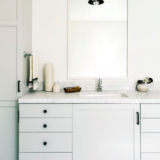 Example of a transitional turquoise floor bathroom design in San Francisco with recessed-panel cabinets, gray cabinets, white walls, an undermount sink and gray countertops