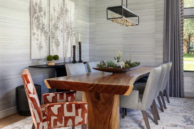 Example of a trendy wallpaper dining room design in Houston with gray walls