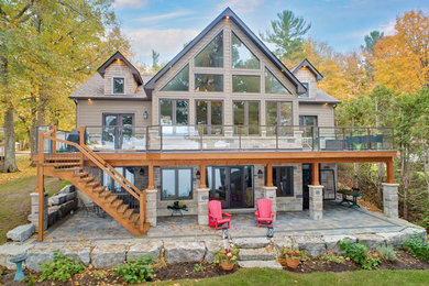 Arts and crafts gray one-story concrete fiberboard exterior home photo in Toronto with a shingle roof