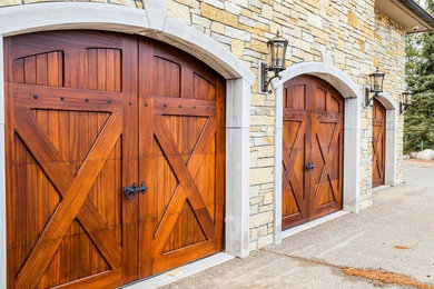 Garage - large traditional attached three-car garage idea in Other