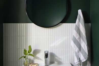 Example of a small trendy white tile and ceramic tile concrete floor and gray floor powder room design in Hawaii with green walls and a wall-mount sink