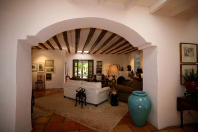 Large southwest formal and open concept terra-cotta tile living room photo in Albuquerque with white walls and no tv