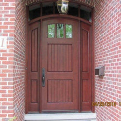 Arched Brick Doorway with an Arch Top Wooden Front Door - Front Doors